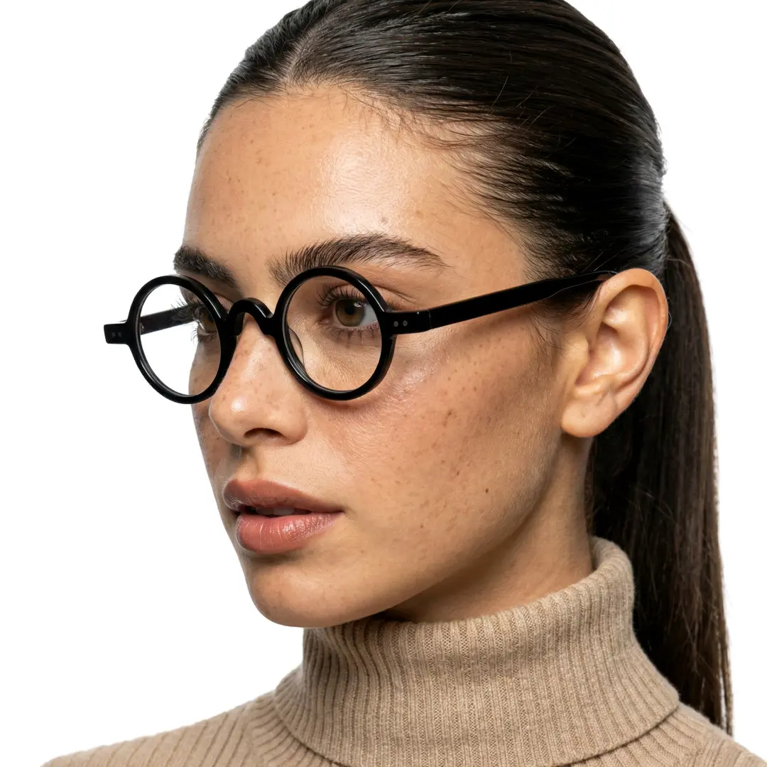 Three-quarter view of female wearing vintage black round eyeglasses, calm expression, RR0322601