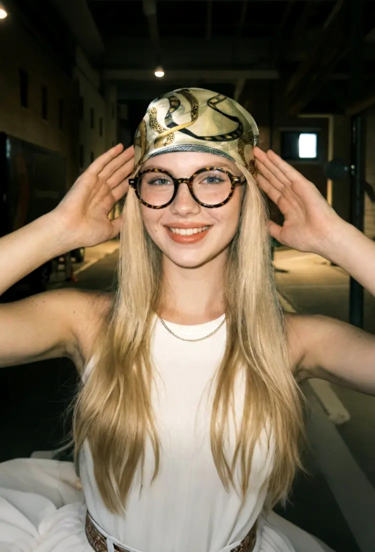 Female model wearing retro brown tortoise round tr90 eyeglasses in an indoor corridor. SPU: RR0332302