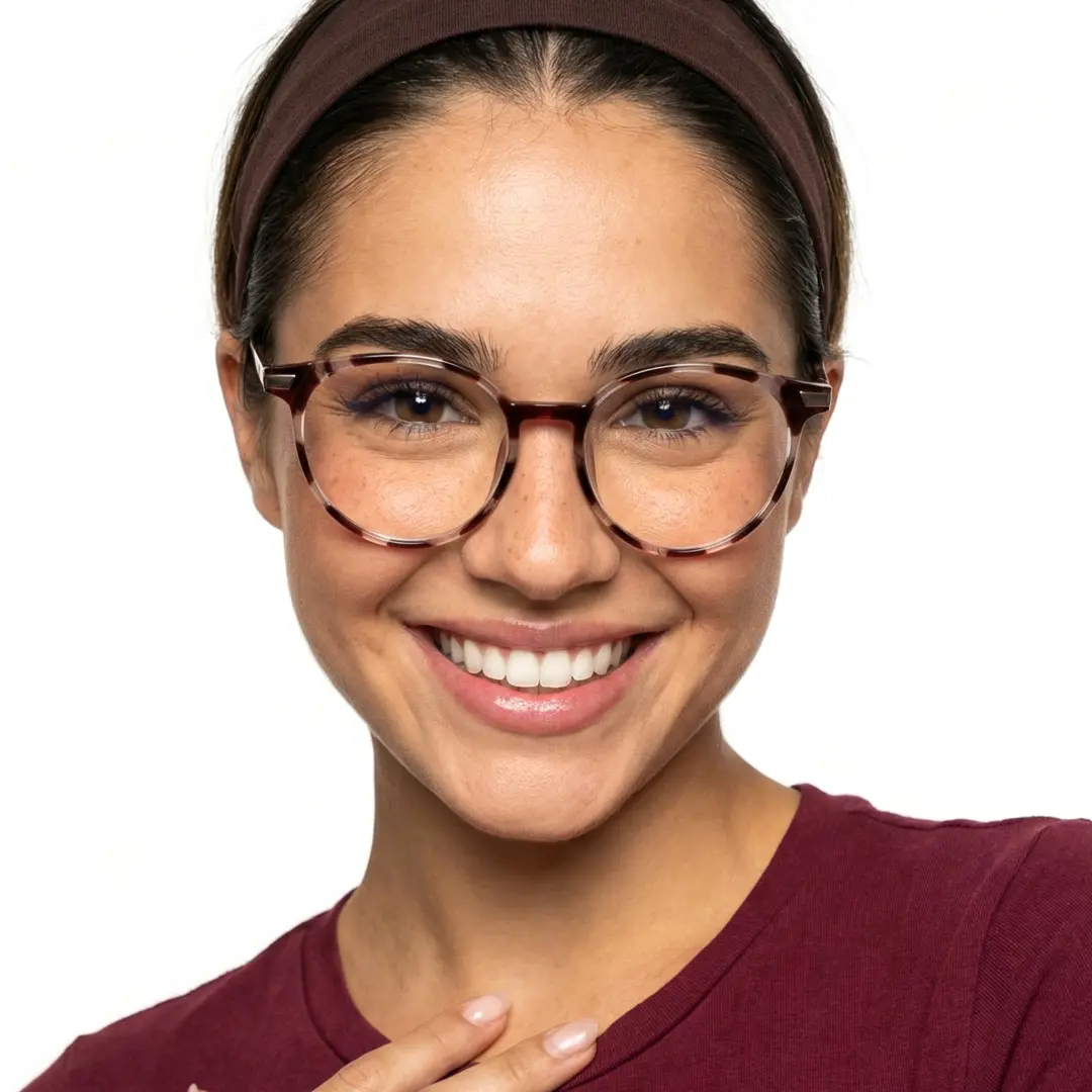 Straight-on view of female wearing tortoise round eyeglasses, wide smile, RR0382504