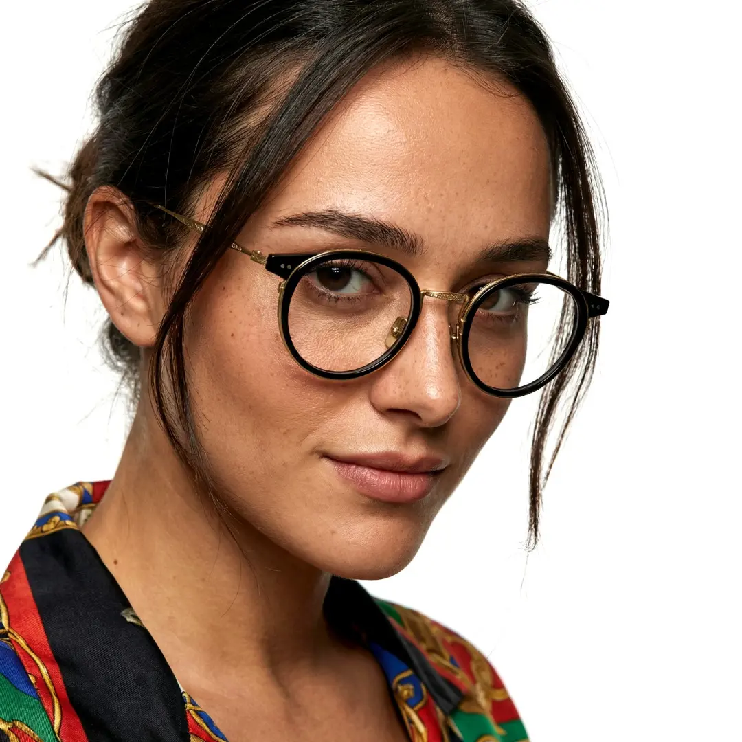 Over-the-shoulder view of female wearing vintage black round eyeglasses, neutral expression, RT0022209
