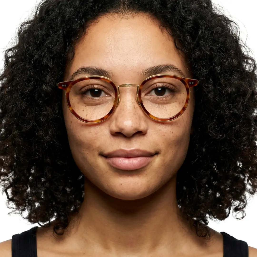 Front view of female wearing yellow tortoise round eyeglasses, natural expression, RT0022209