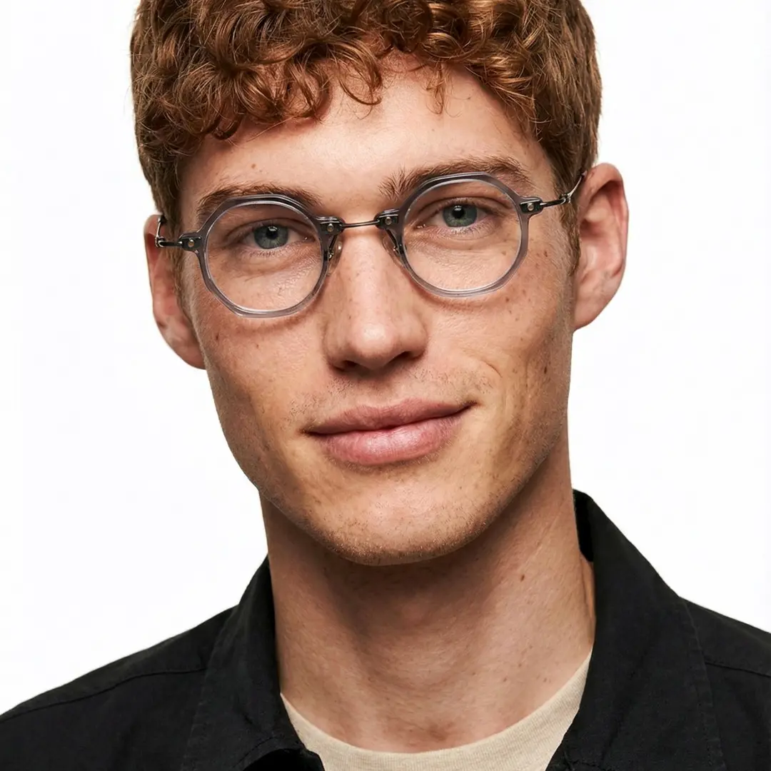 Tilted head view of male wearing steampunk grey round eyeglasses, calm expression, RT0042306