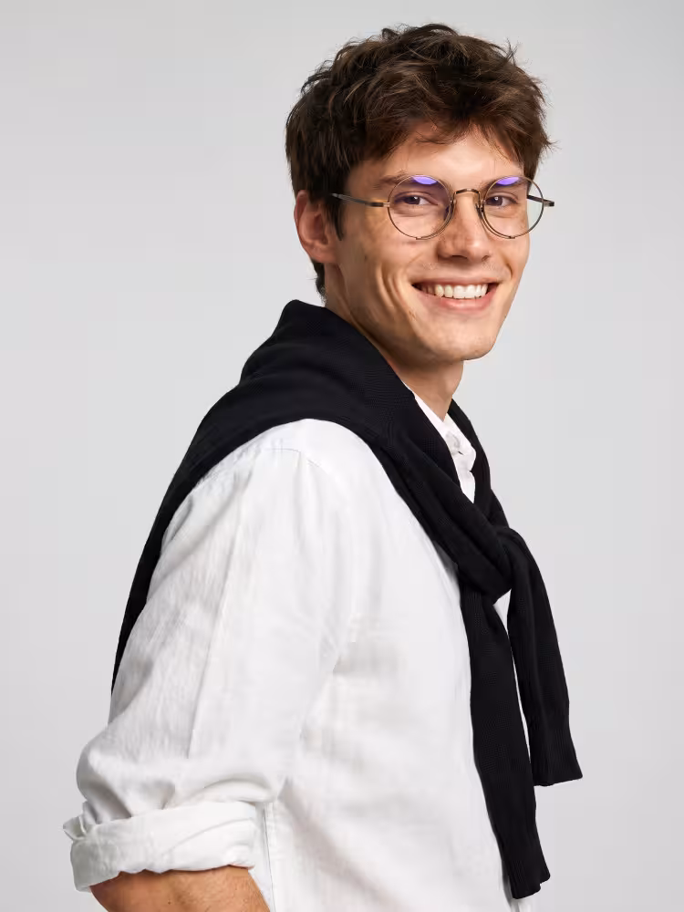 Male model wearing fashion bronze round titanium eyeglasses against plain grey studio background. SPU: RT0052304