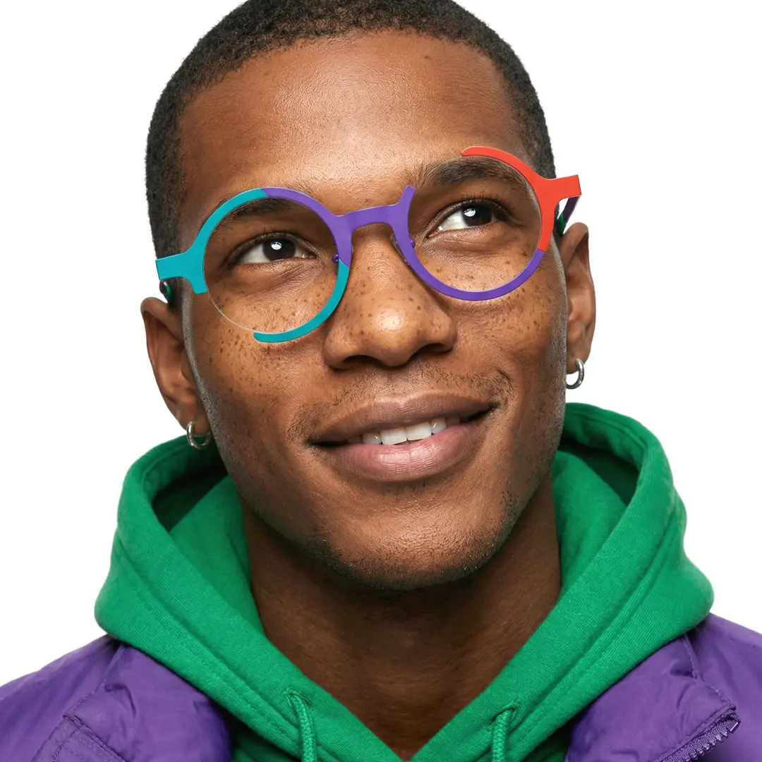 Front view of male wearing colorful multicolor round eyeglasses, natural smile, RT0072407