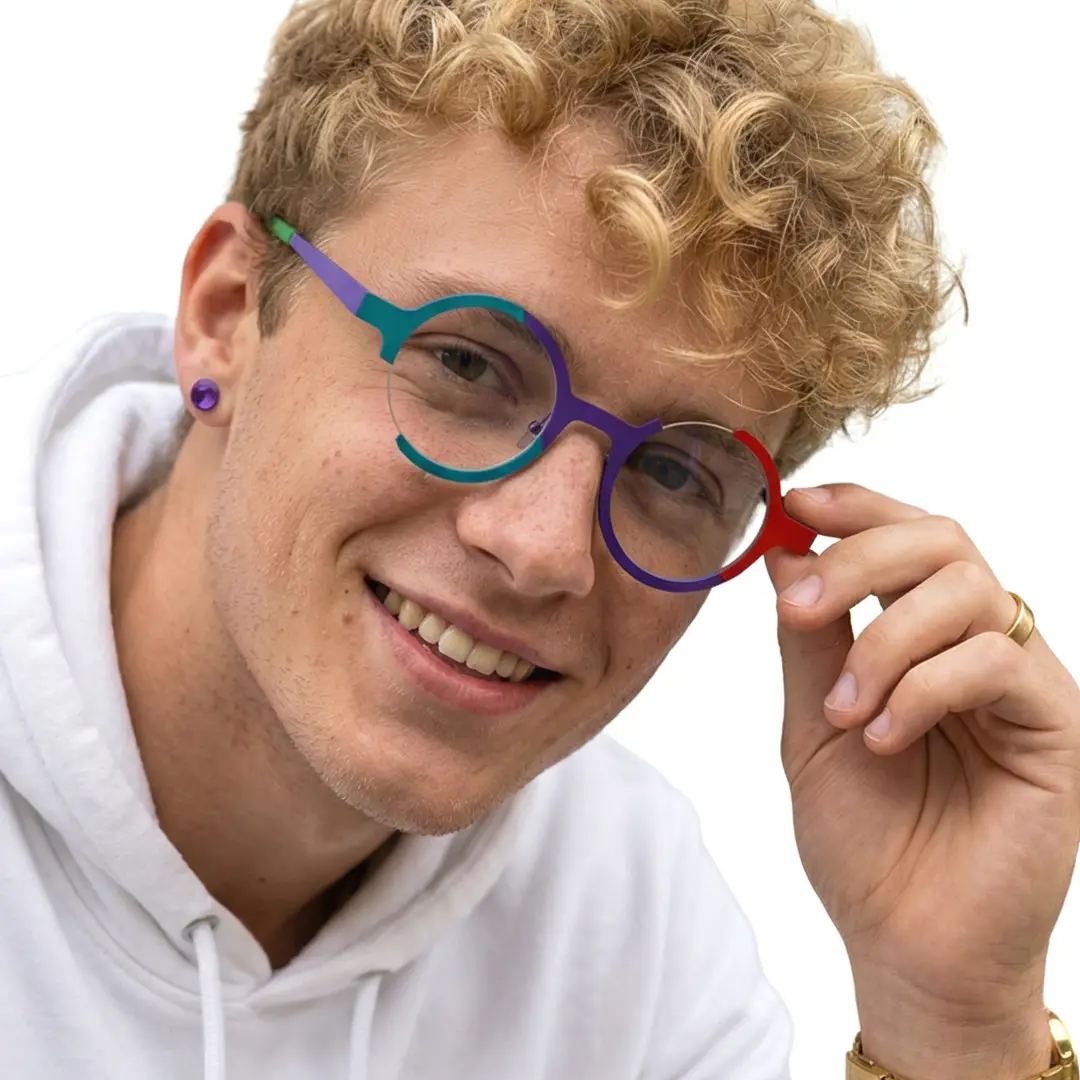 Front view of male wearing colorful multicolor round eyeglasses, touching frame, smiling, RT0072407