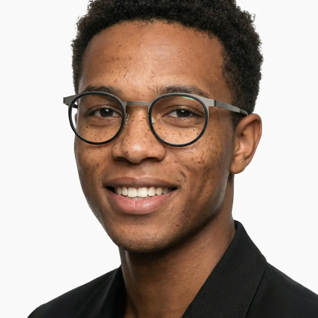 Front view of male wearing silver round eyeglasses, smiling, RT0212306