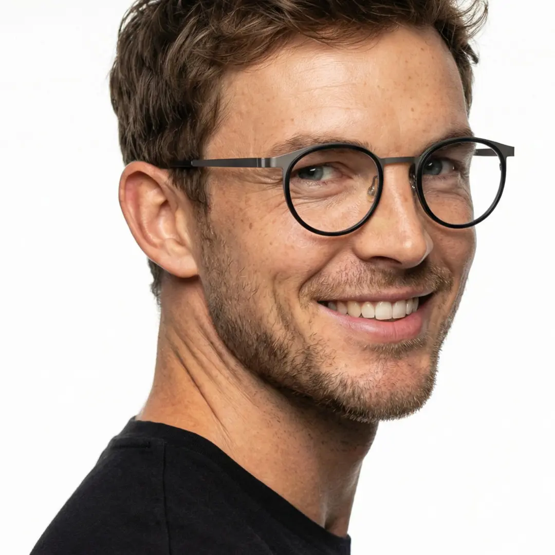 Over-the-shoulder view of male wearing silver round eyeglasses, natural smile, RT0212306