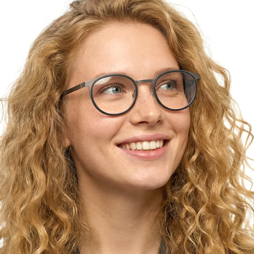 Front view of female wearing silver round eyeglasses, smiling, RT0212306