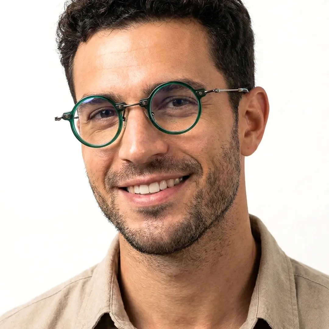 Looking straight ahead view of male wearing steampunk green round eyeglasses, friendly smile, RT0302406