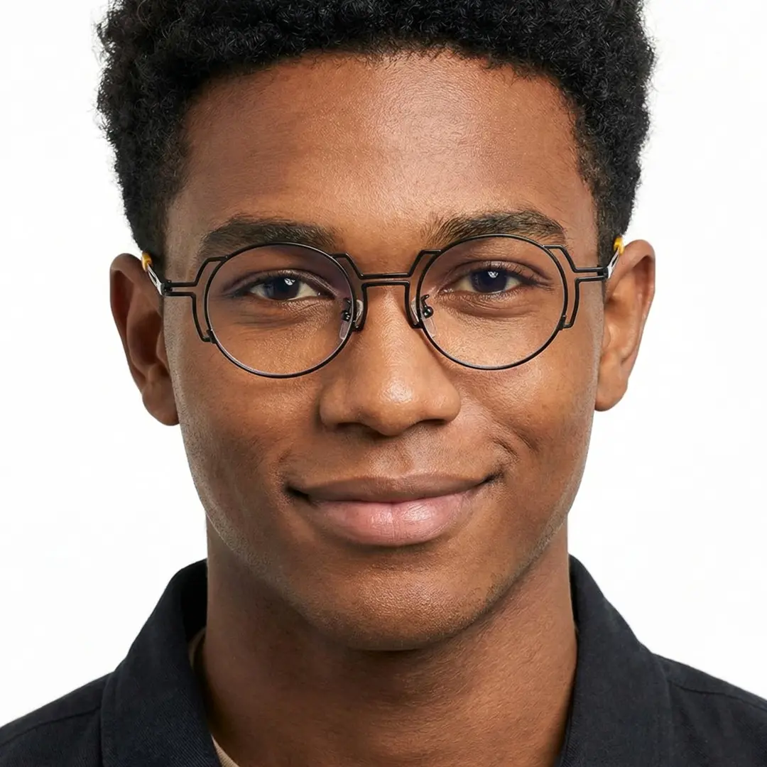 Front view of male wearing steampunk black round eyeglasses, friendly smile, RT0522509