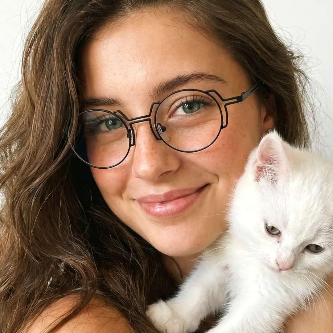 Front view of female wearing steampunk black round eyeglasses, soft smile, RT0522509