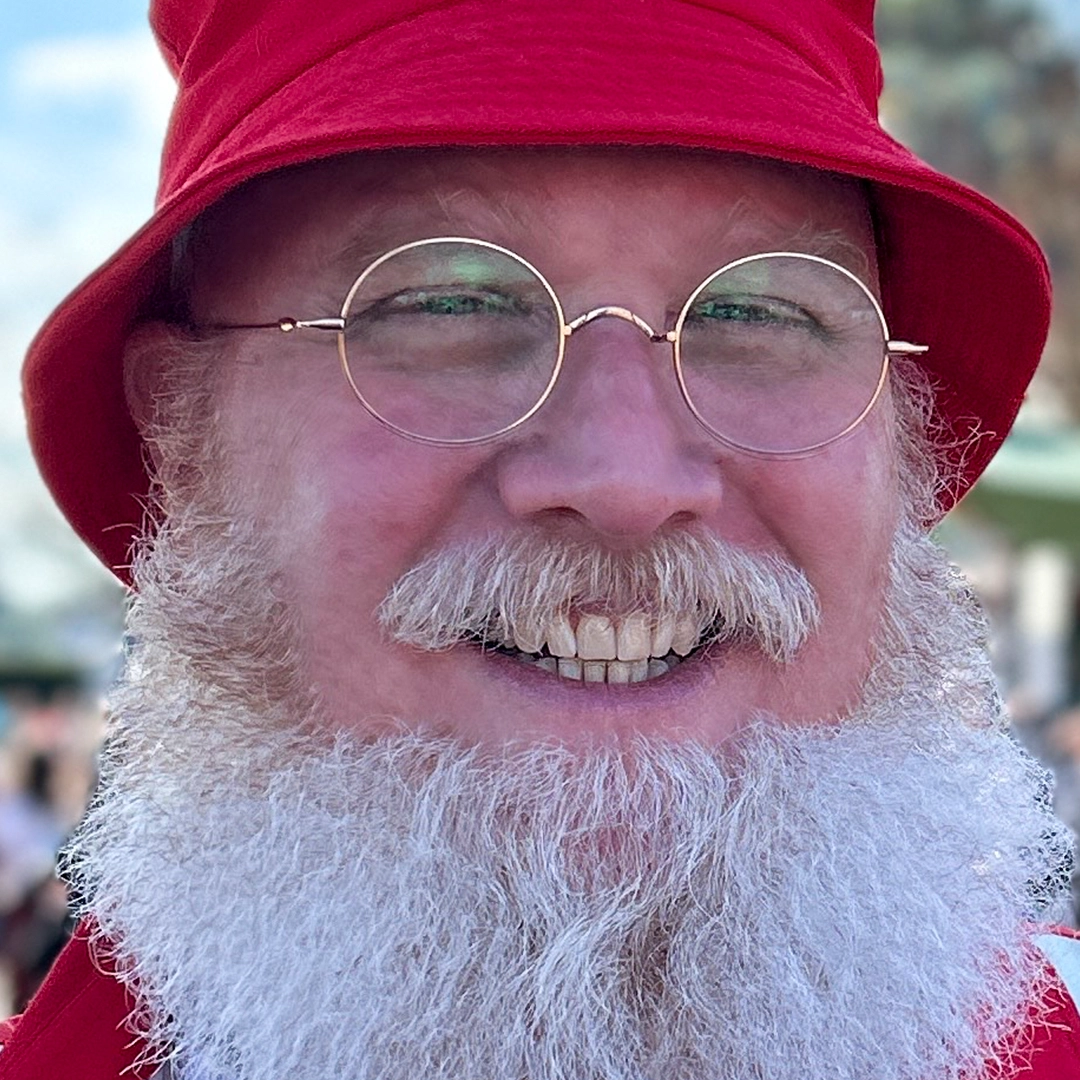 Front view of male wearing vintage gold round eyeglasses, natural smile, RT0942508