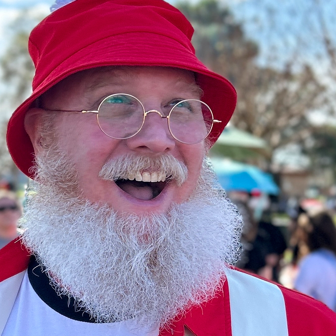 Front view of male wearing vintage gold round eyeglasses, wide smile, RT0942508