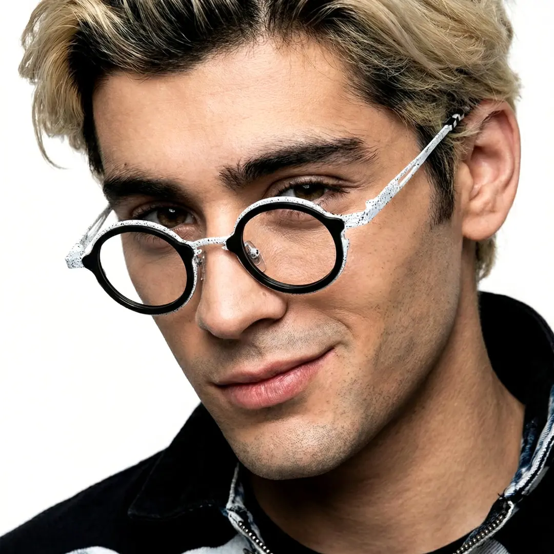 Three-quarter view of male wearing black round eyeglasses, smiling, RT0962508