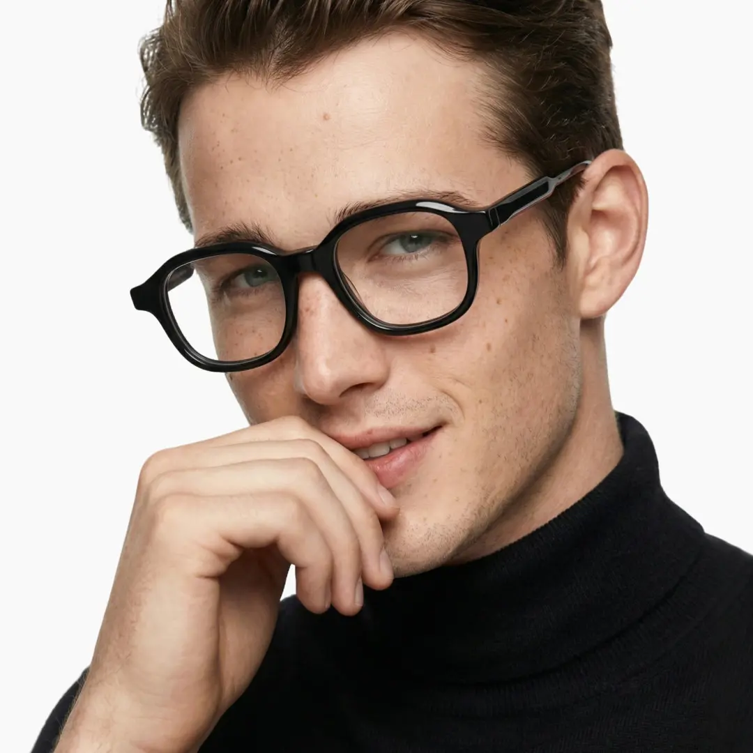 Front view of male wearing black square eyeglasses, resting chin on hand, natural smile, SA0052312
