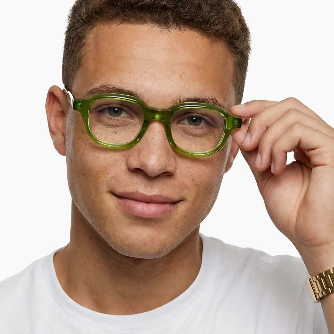 Front view of male wearing green square eyeglasses, touching frame, natural smile, SA0052312