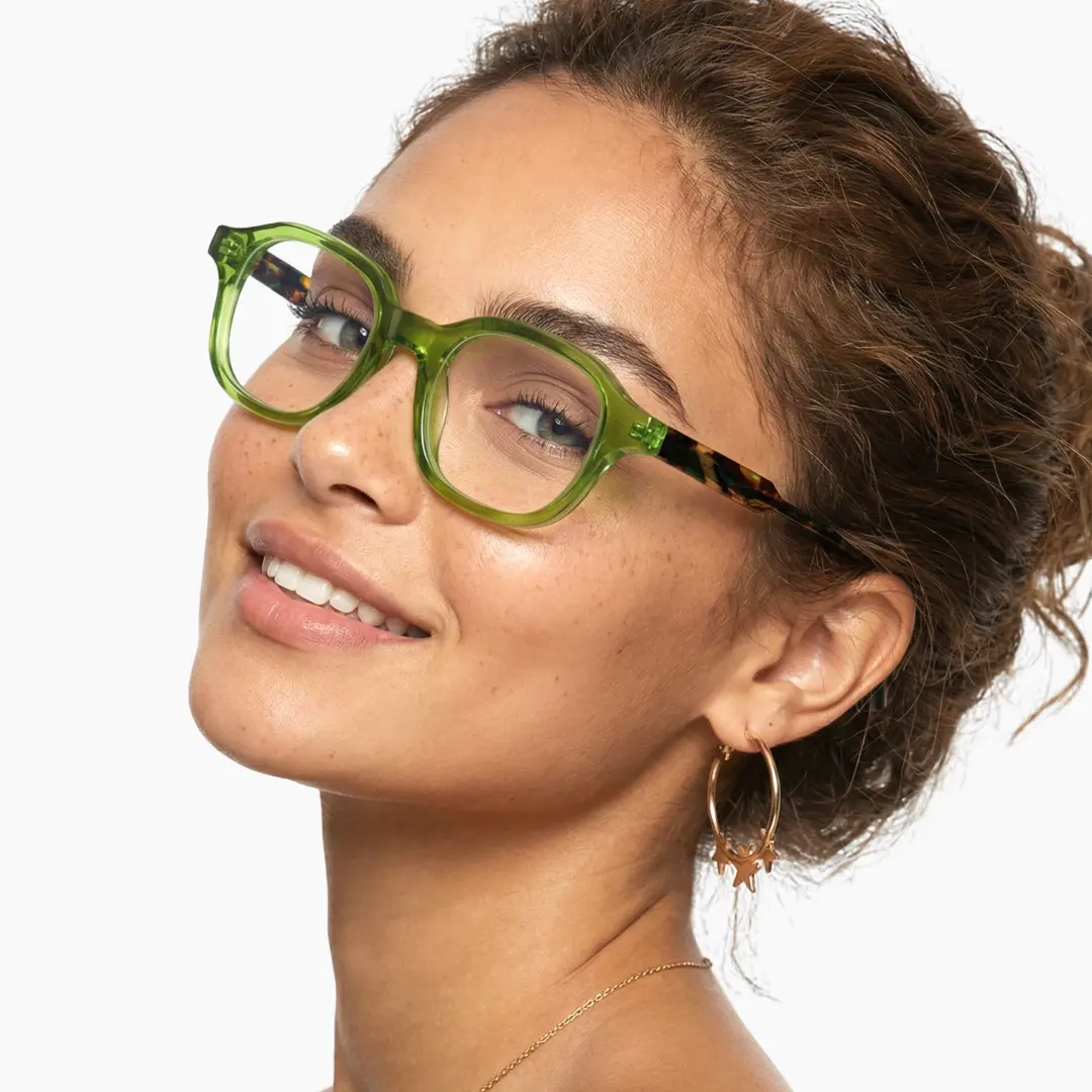 Profile view of female wearing green square eyeglasses, natural smile, SA0052312