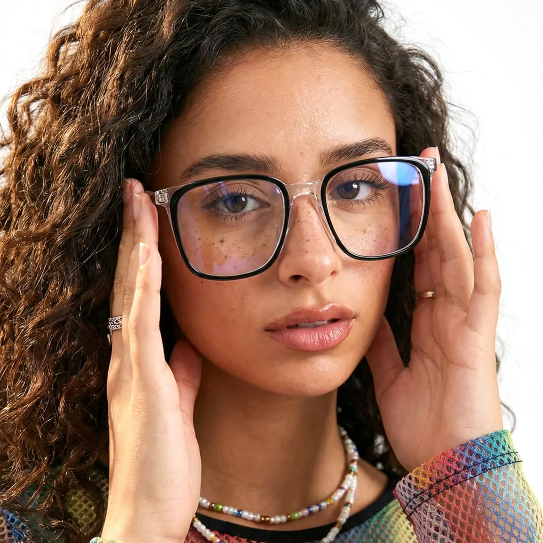 Front view of female wearing black clear square eyeglasses, adjusting glasses, natural expression, SA0082305