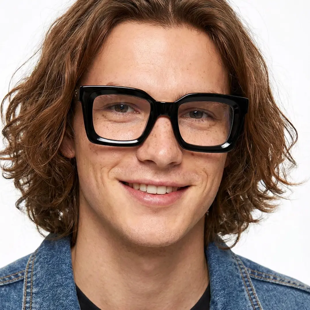 Looking straight ahead view of male wearing black square eyeglasses, neutral expression, SA0142406