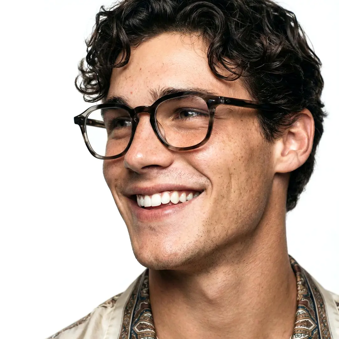 Profile view of male wearing grey square eyeglasses, smiling, SA0232403