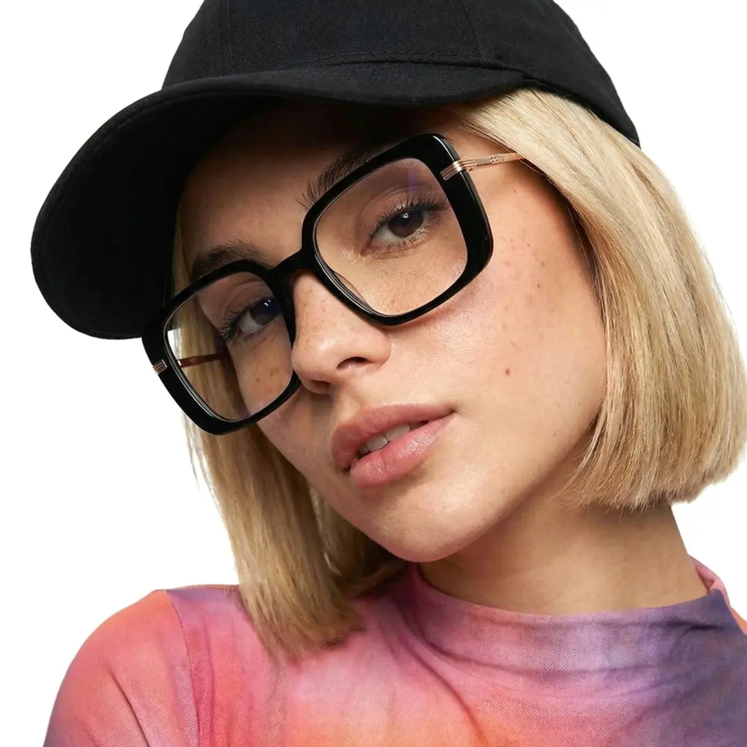 Tilted head view of female wearing black square eyeglasses, soft smile, SA0392503