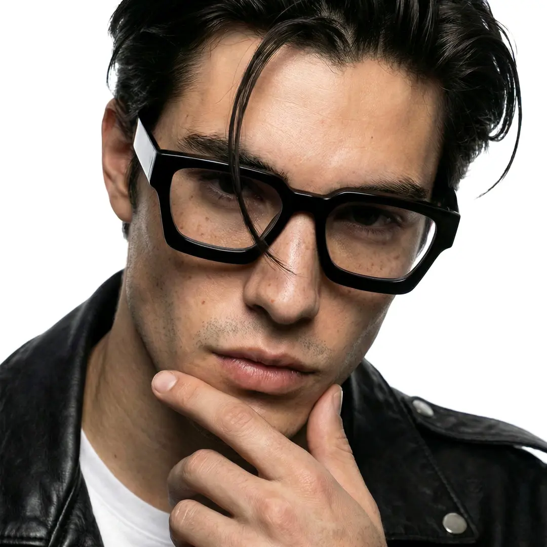 Slightly angled view of male wearing black square eyeglasses, resting chin on hand, calm expression, SA0552302