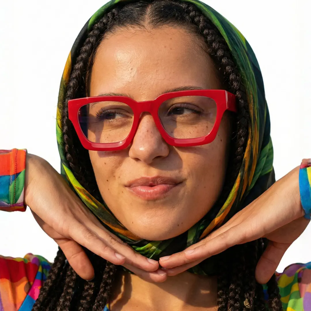Looking away view of female wearing red square eyeglasses, soft smile, SA0552302