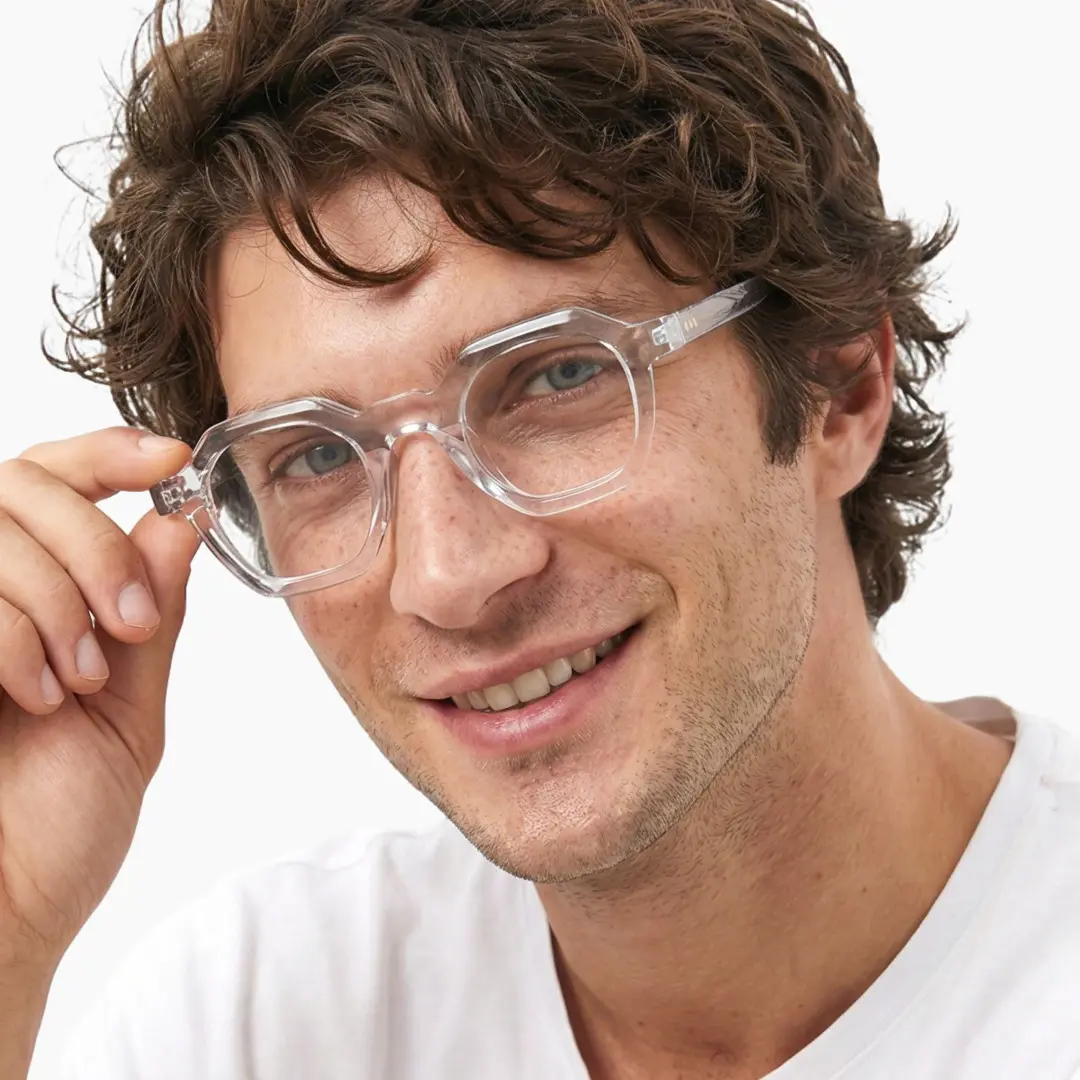 Three-quarter view of male wearing clear square eyeglasses, adjusting glasses, natural smile, SA0812302