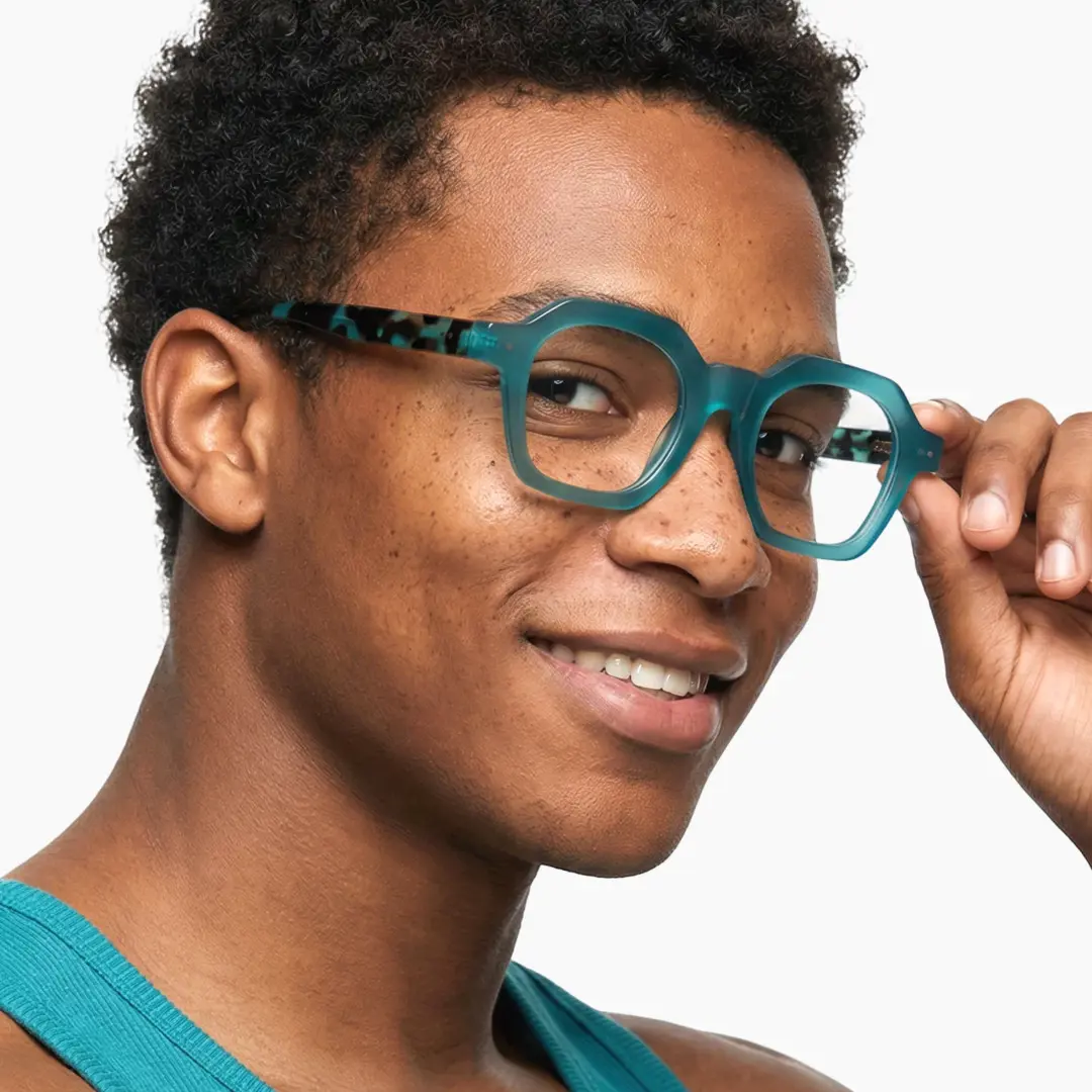 Profile view of male wearing light blue square eyeglasses, touching frame, smiling, SA0812302