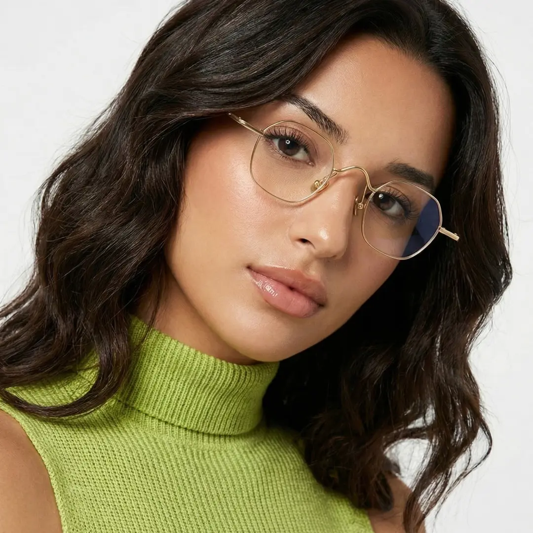 Front view of female wearing vintage gold square eyeglasses, tilting head, natural expression, SM0192411