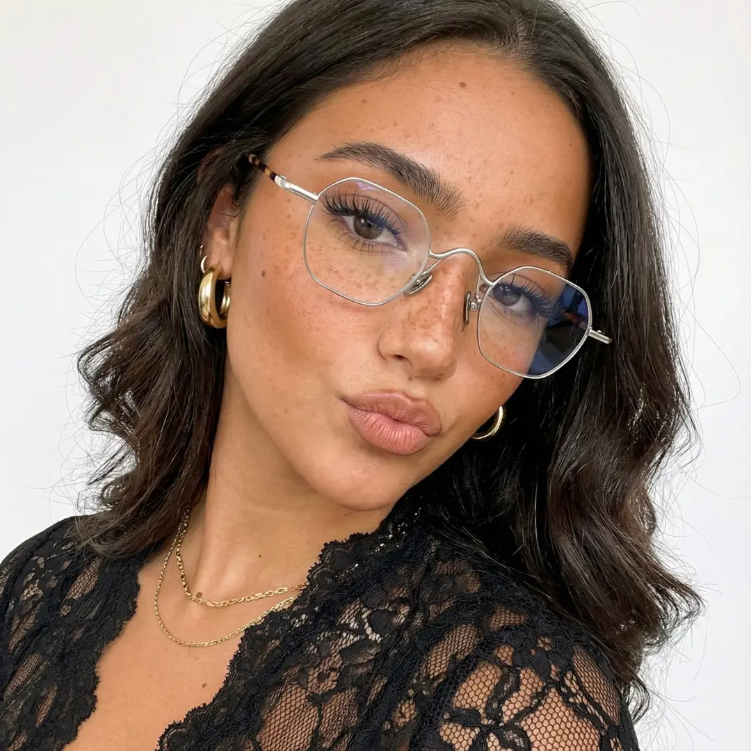 Front view of female wearing vintage silver square eyeglasses, tilting head, confident expression, SM0192411