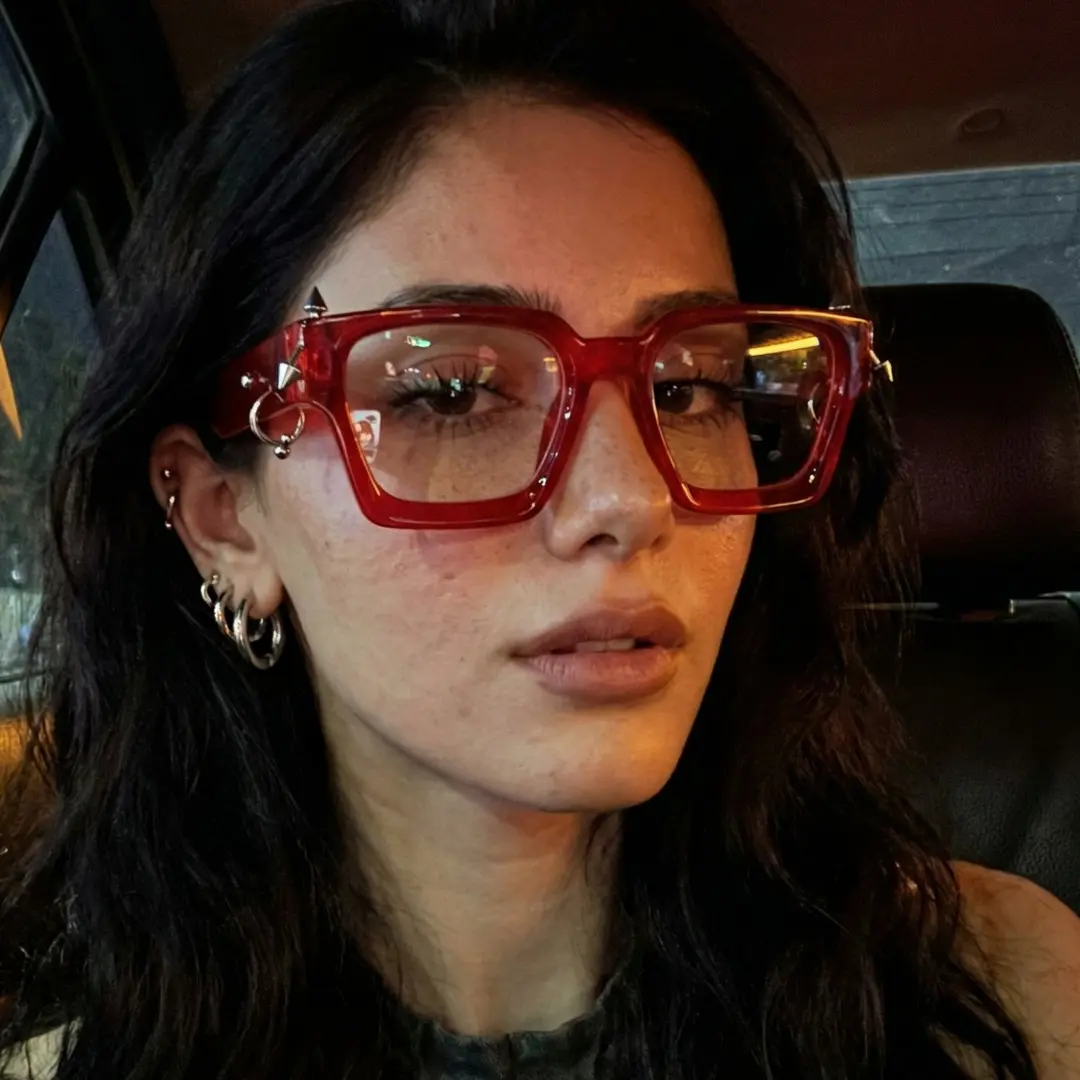 Front view of female wearing red square eyeglasses, taking a selfie, natural expression, SP0012511