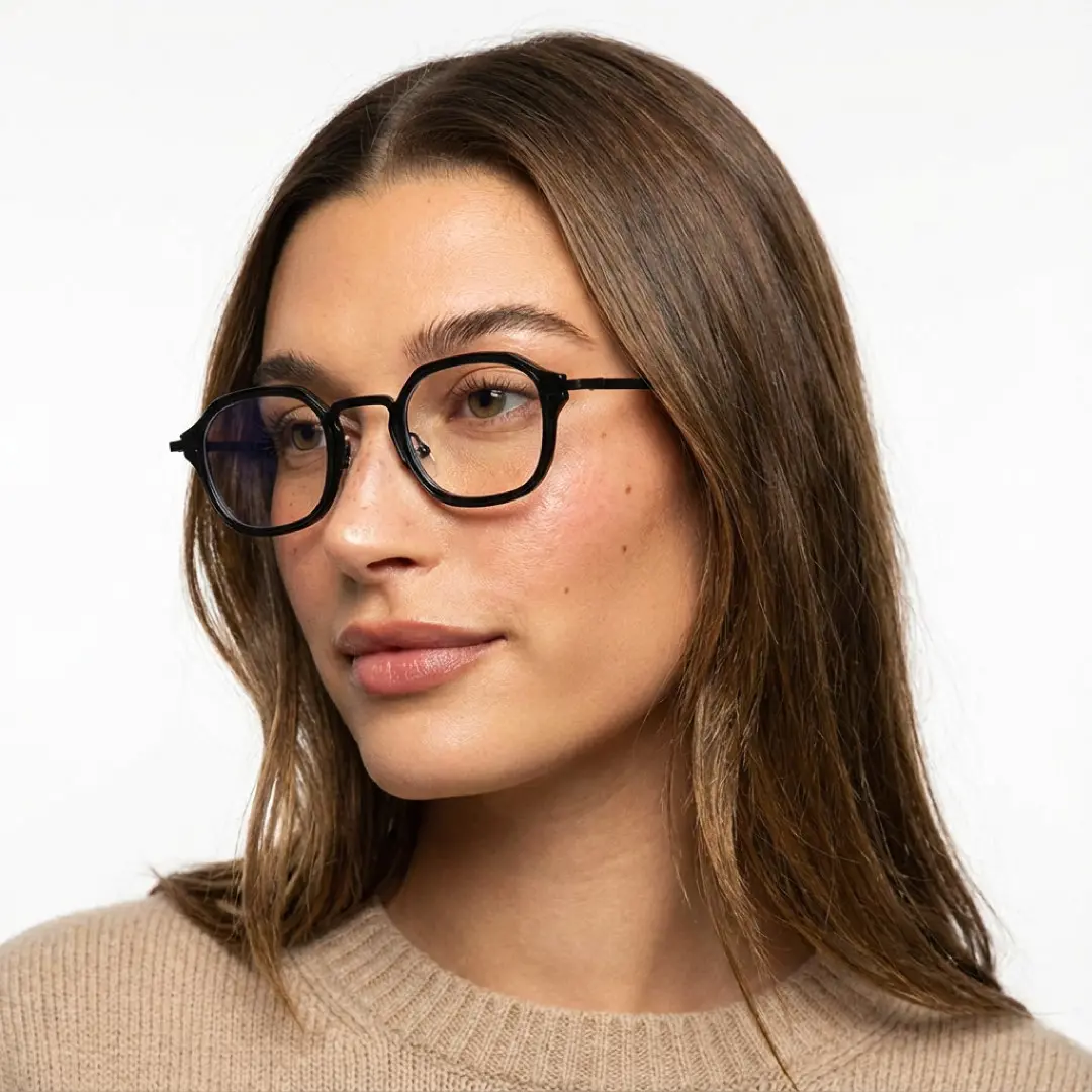 Front view of female wearing black square eyeglasses, tilting head, relaxed expression, SP0042207