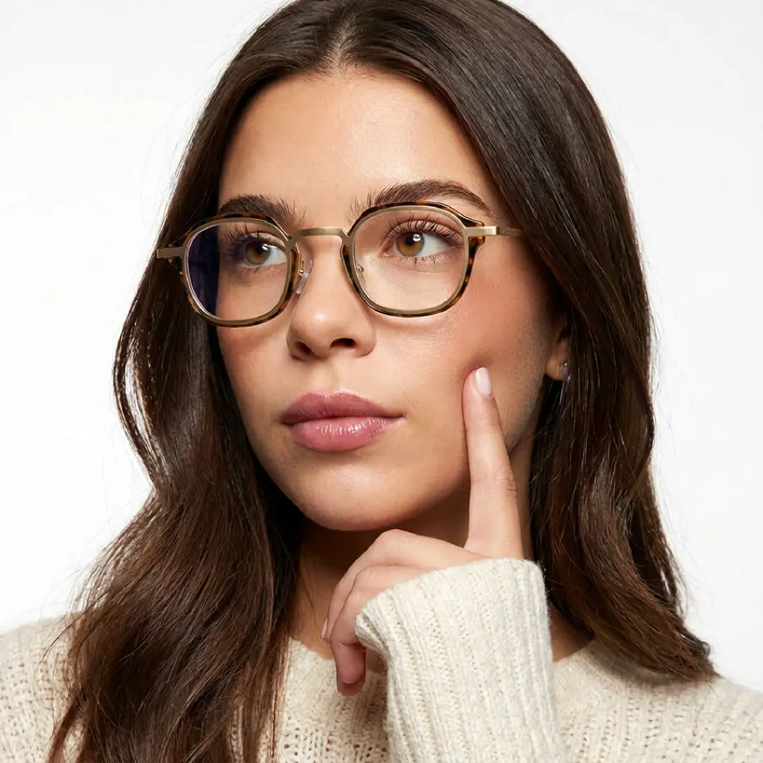 Three-quarter view of female wearing tortoise square eyeglasses, finger touching face, neutral expression, SP0042207