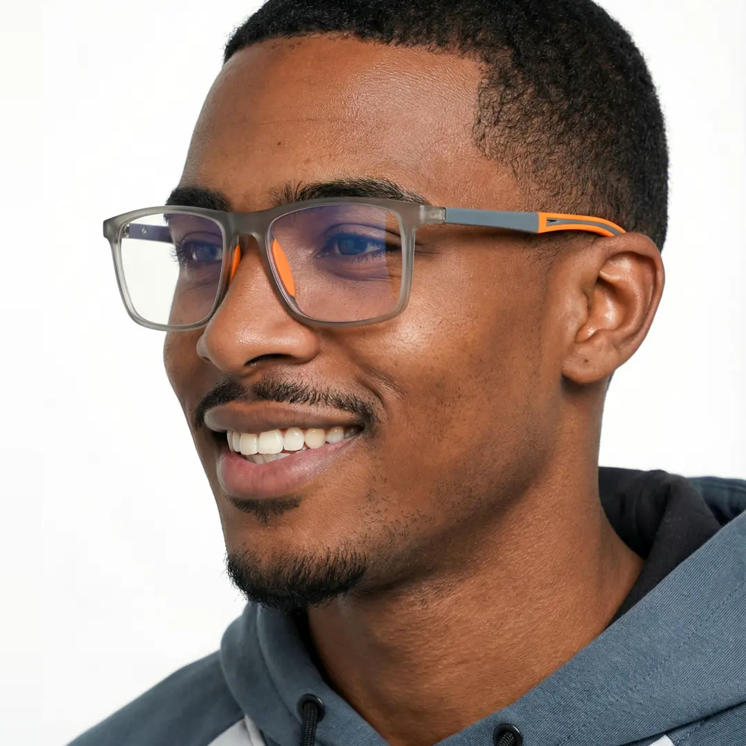 Profile view of male wearing orange square eyeglasses, smiling, SP0042503