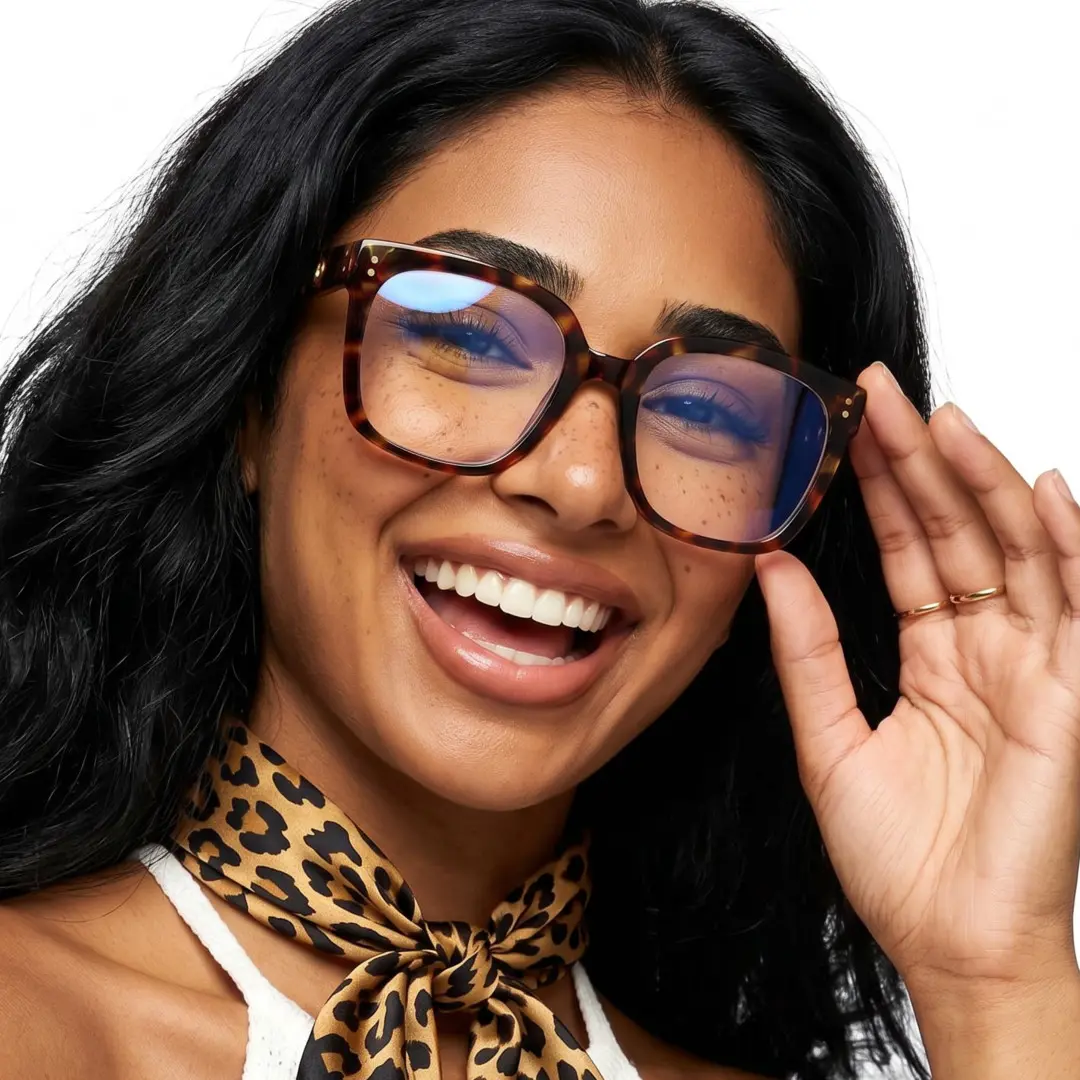 Three-quarter view of female wearing tortoise square eyeglasses, touching frame, smiling, SP0062508