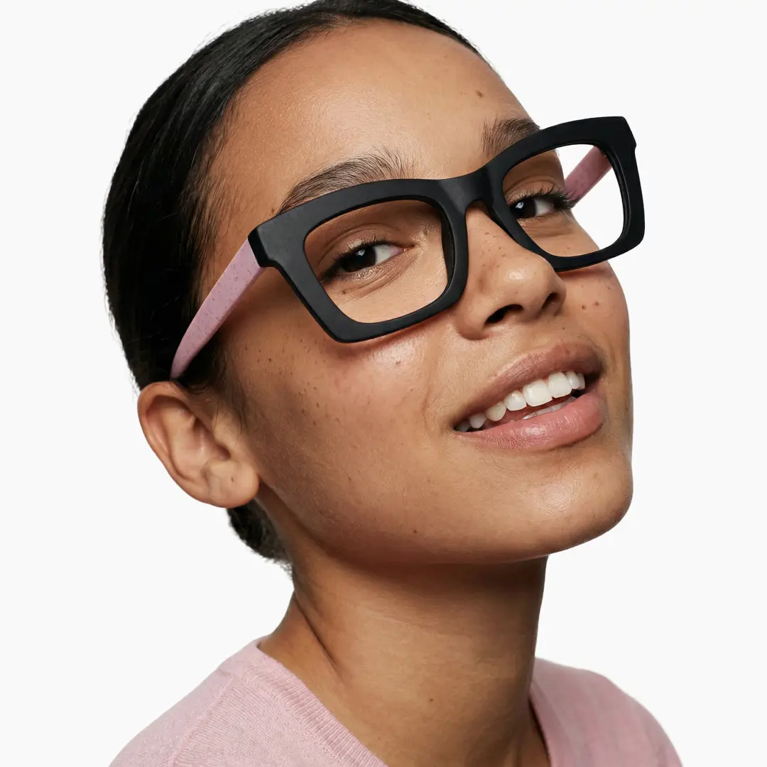 Over-the-shoulder view of female wearing pink square eyeglasses, natural smile, SP0082408