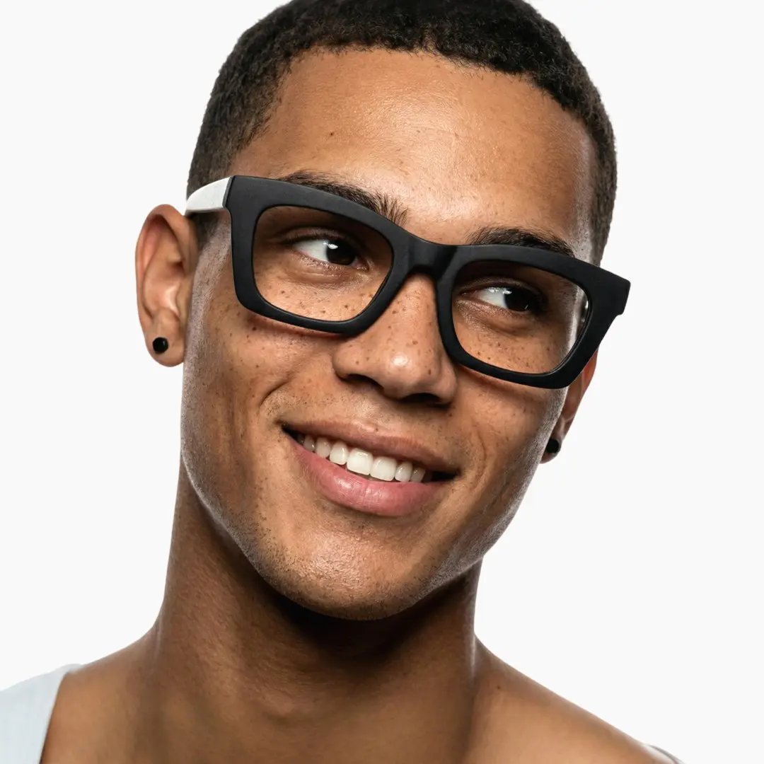 Looking away view of male wearing white square eyeglasses, natural smile, SP0082408