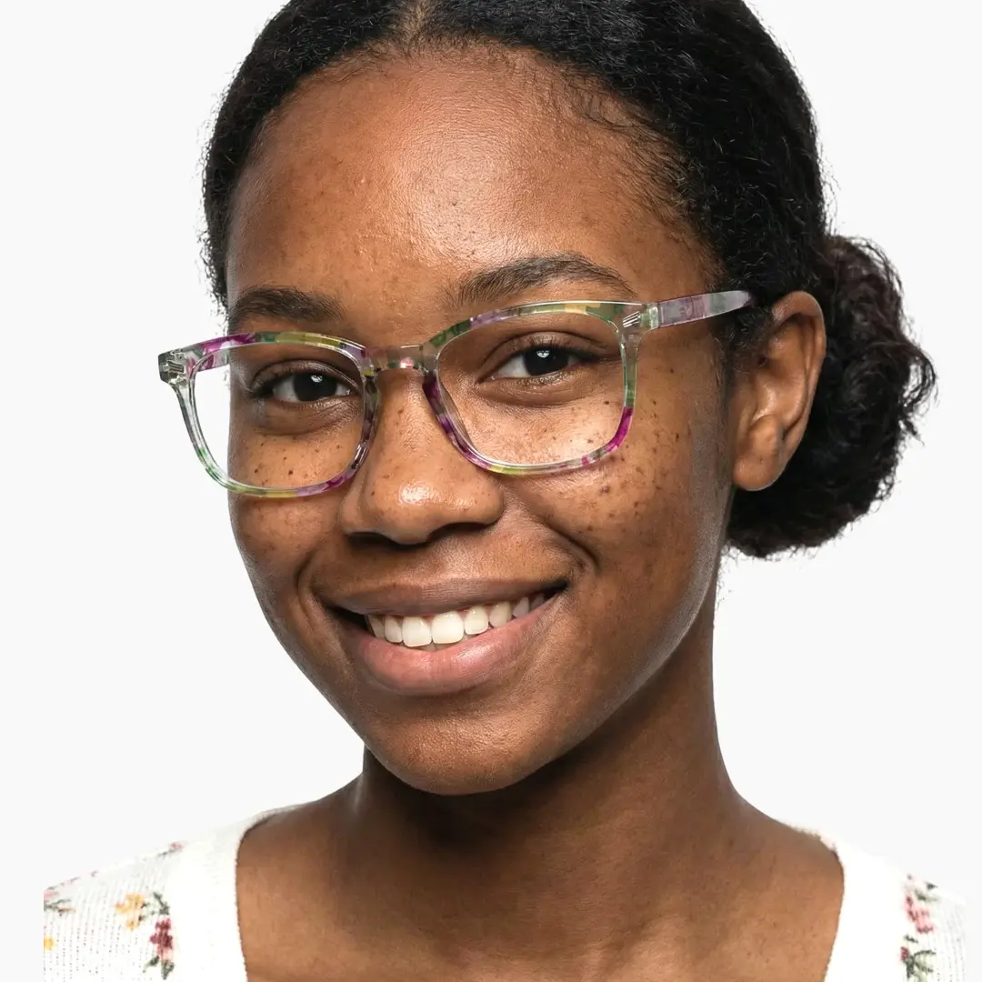 Slightly angled view of female wearing green square eyeglasses, smiling, SP0112308