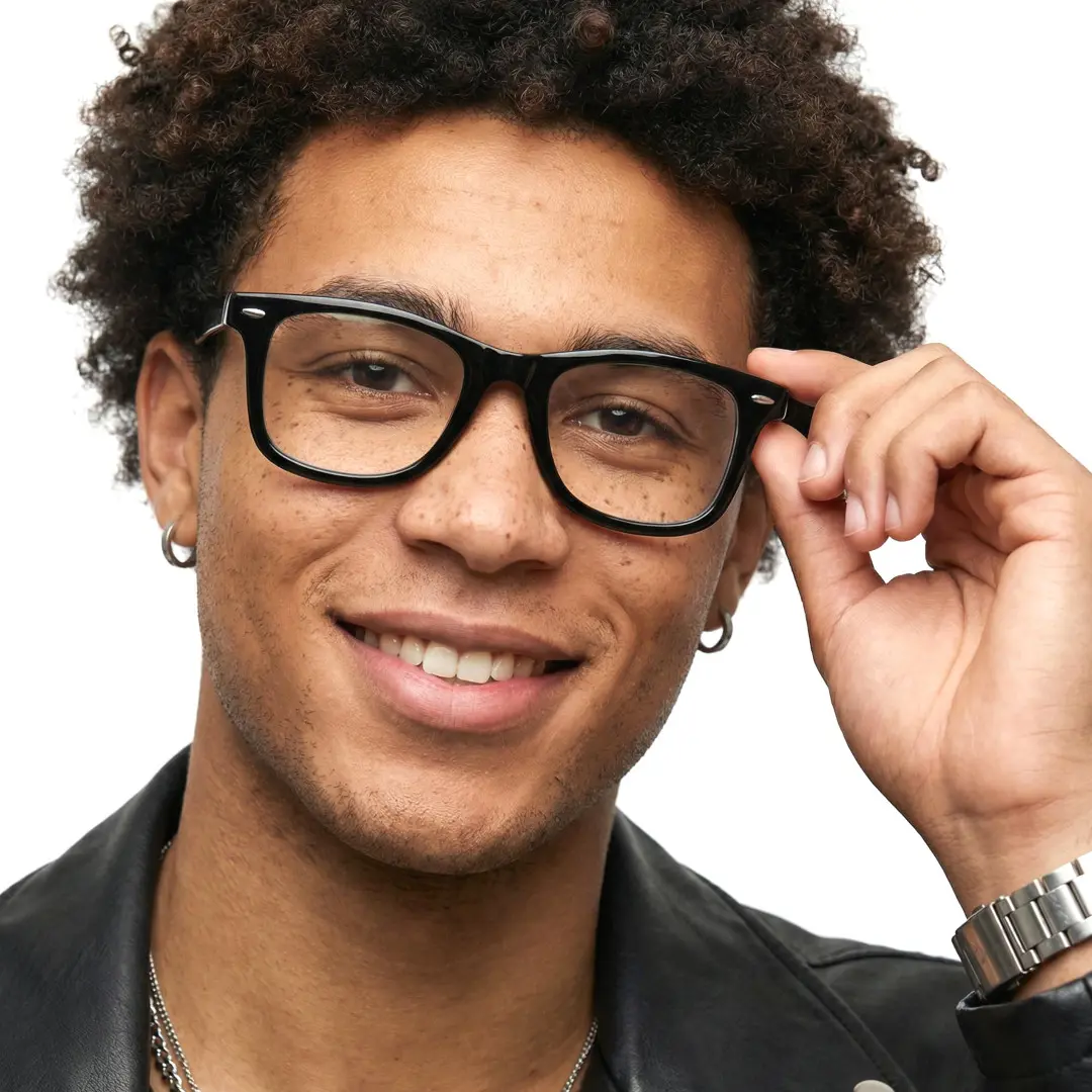 Profile view of male wearing black square eyeglasses, holding glasses, soft smile, SP0112409