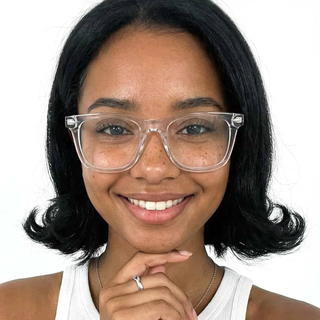 Front view of female wearing clear square eyeglasses, resting chin on hand, soft smile, SP0112409