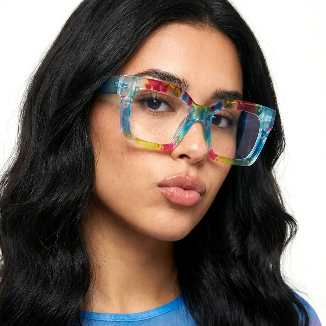 Looking straight ahead view of female wearing colorful blue square eyeglasses, pouting, neutral expression, SP0122406
