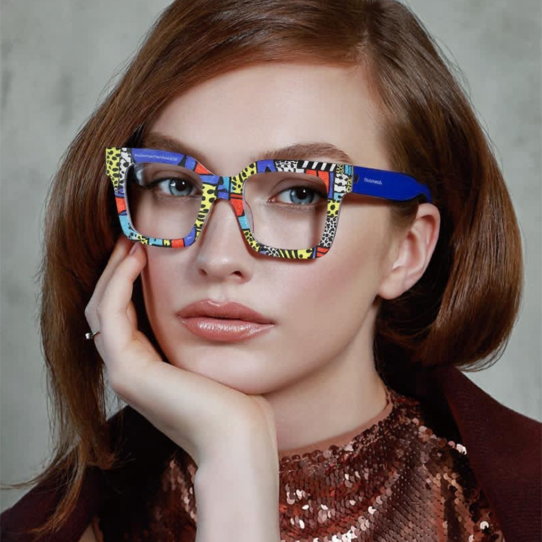 Front view of female wearing colorful multicolor square eyeglasses, resting chin on hand, relaxed expression, SP0122406