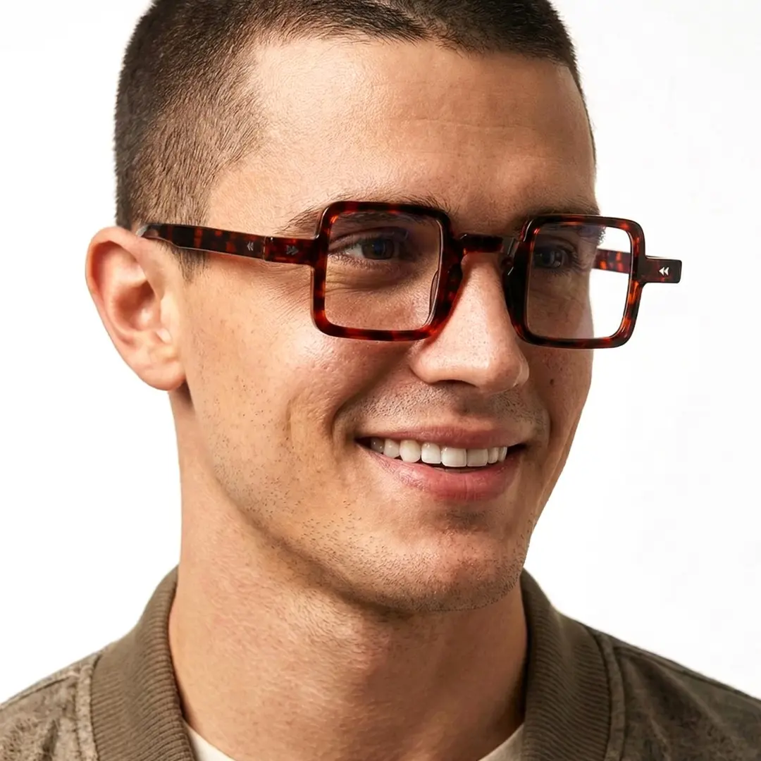 Three-quarter view of male wearing vintage tortoise square eyeglasses, natural smile, SP0352411