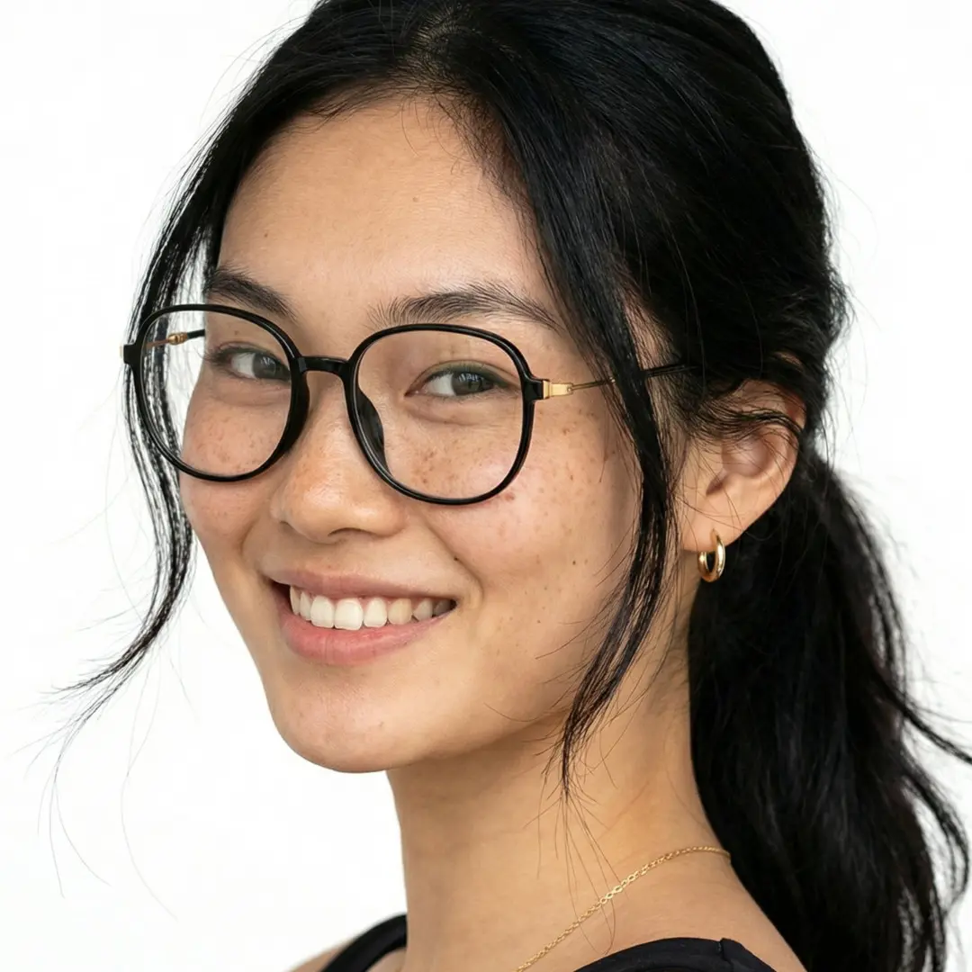 Over-the-shoulder view of female wearing black square eyeglasses, soft smile, SR0012411