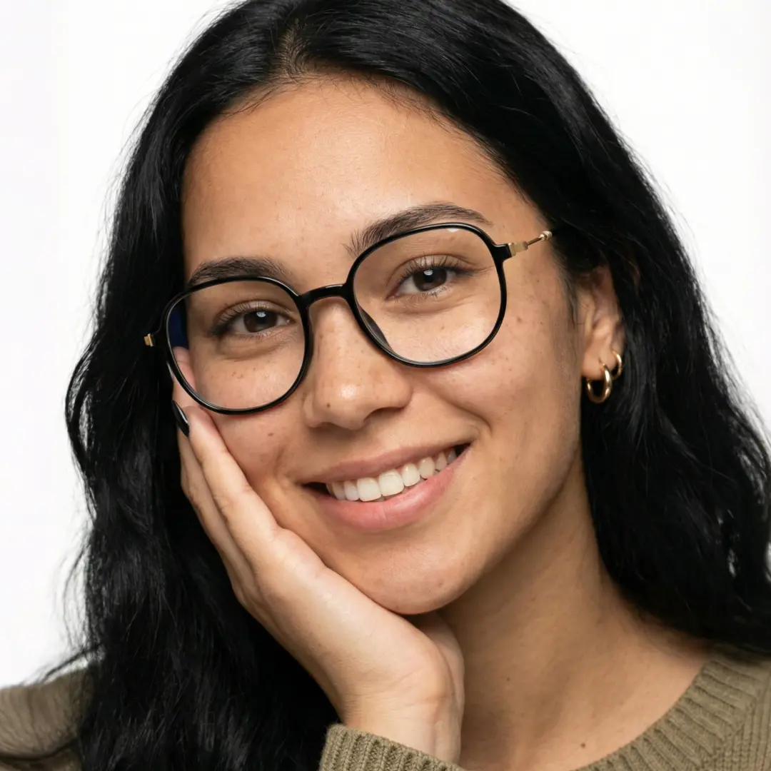 Front view of female wearing black square eyeglasses, resting chin on hand, smiling, SR0012411