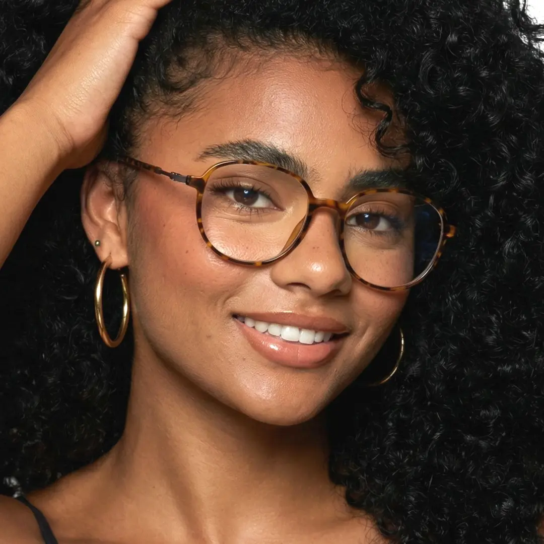 Front view of female wearing tortoise square eyeglasses, smiling, SR0012411