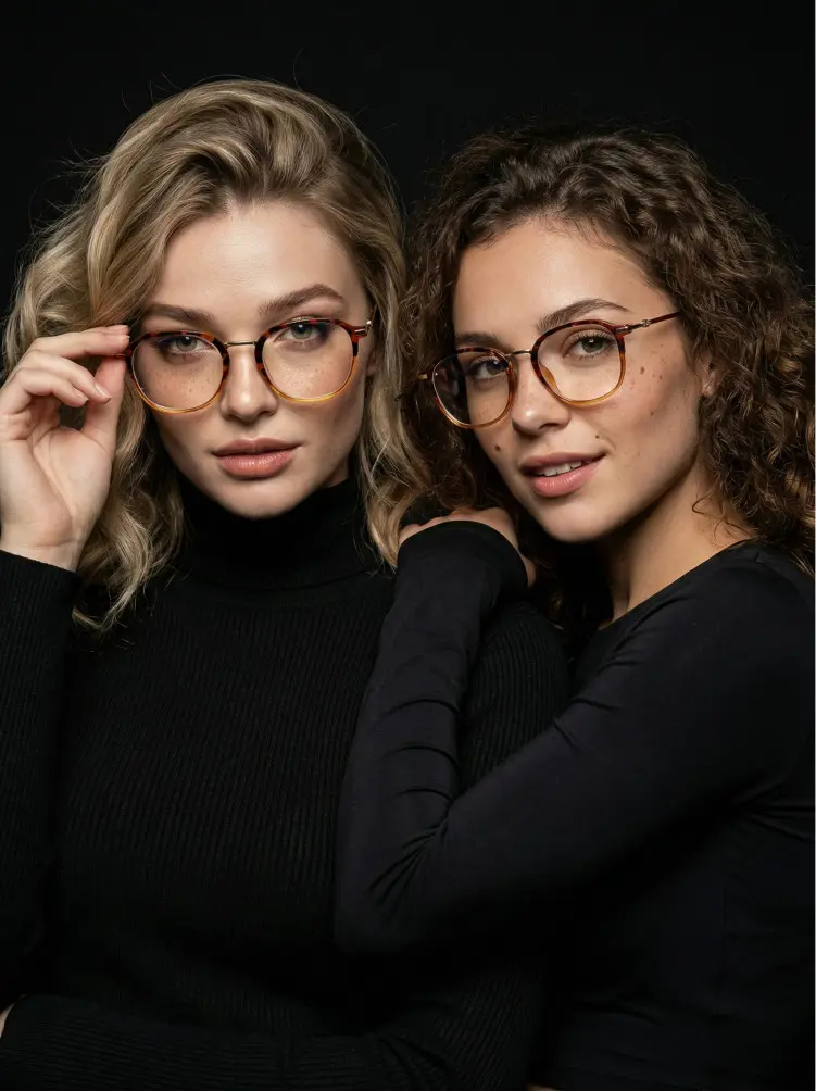 Two people models wearing vintage tortoise square tr90 eyeglasses in a dark studio portrait setting. SPU: SR0012502