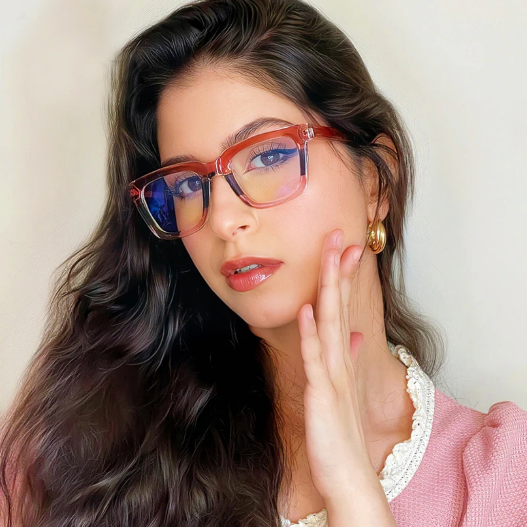 Three-quarter view of female wearing colorful pink square eyeglasses, hand near face, neutral expression, SR0022402