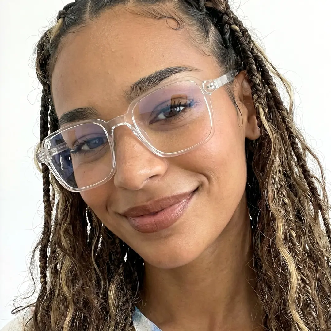 Front view of female wearing vintage clear square eyeglasses, tilting head, natural smile, SR0022508